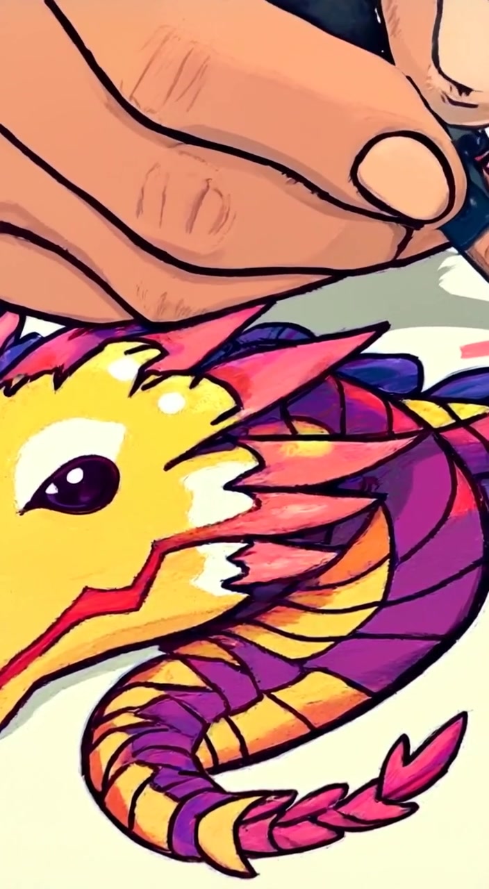 The hand gently sketches intricate details of a dragon on the page, colors slowly blending into the vibrant doodle.