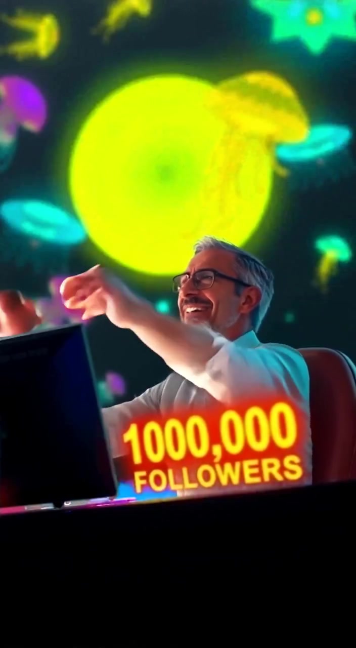 The man raises his arms in celebration as confetti gently falls around him.