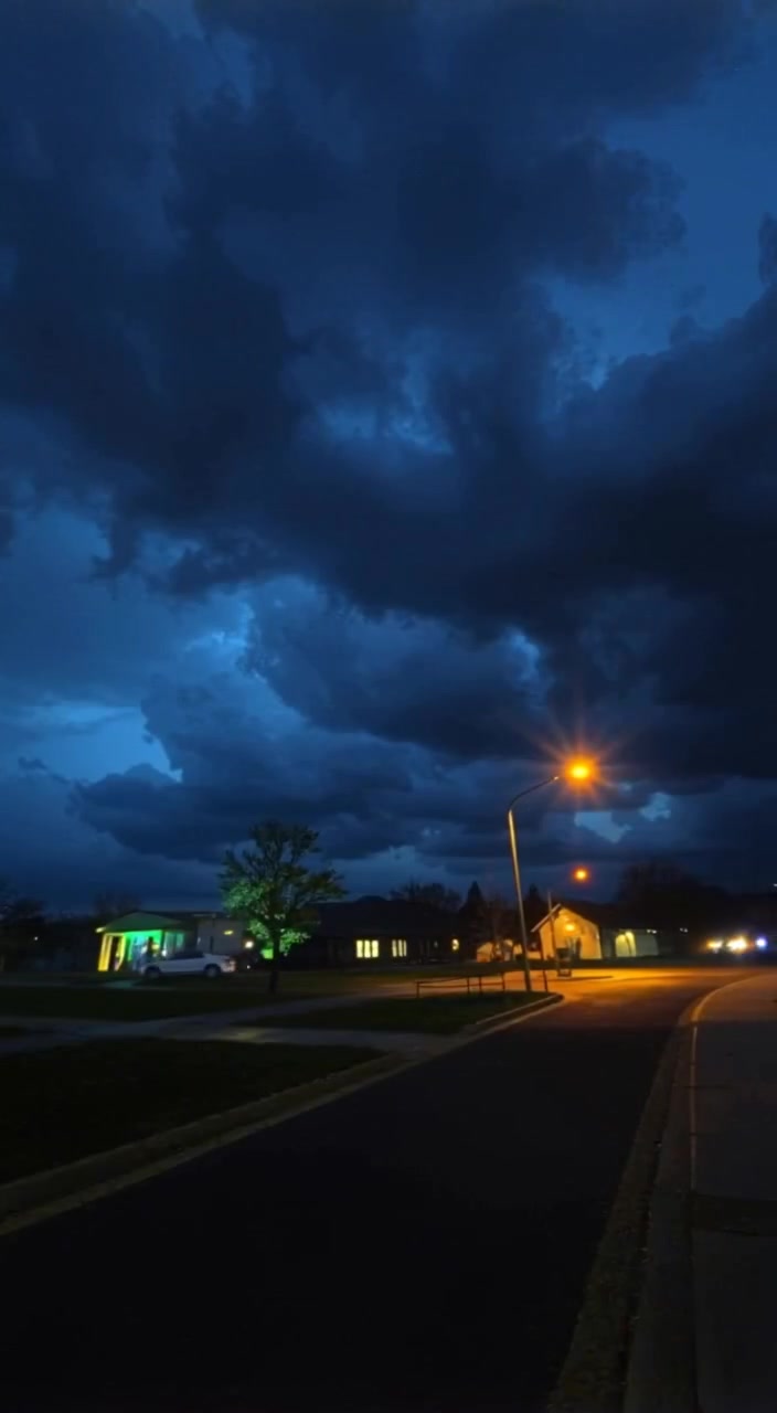 The area near a barrier under a cloudy sky, with dark clouds looming overhead.