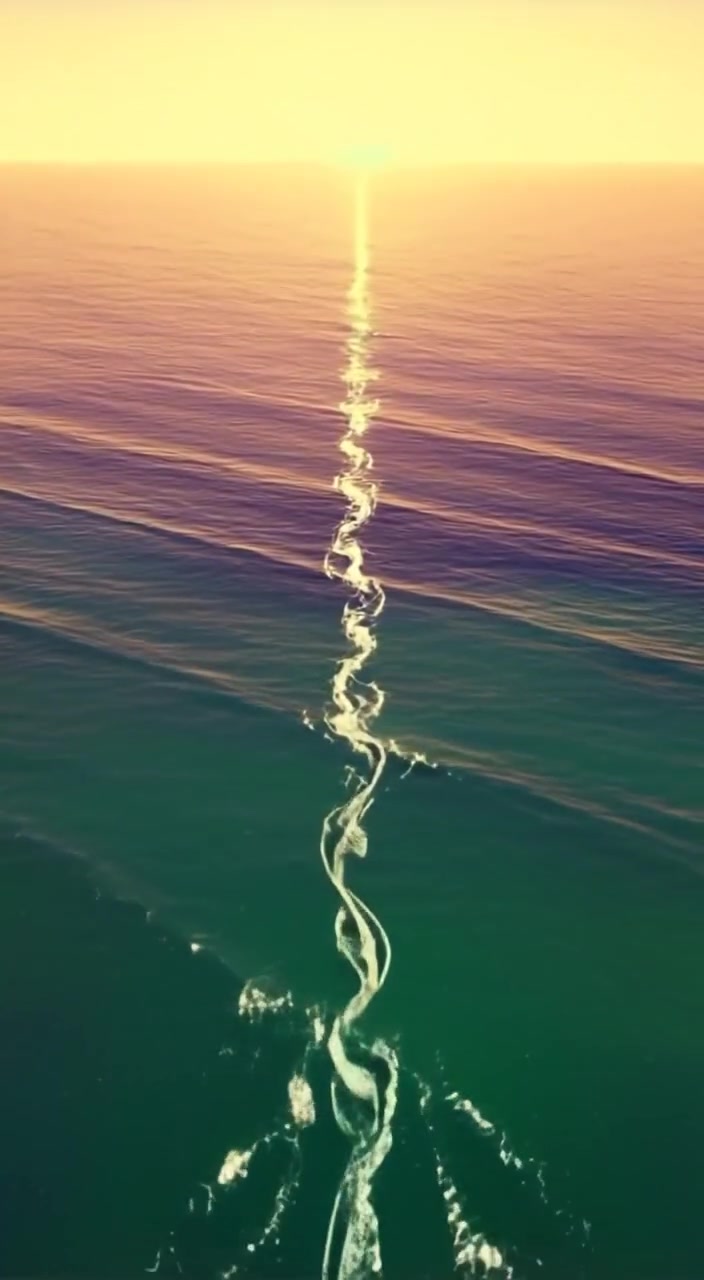 Waves gently collide at the division of two oceans, creating a mesmerizing, clear line between blue and green waters.