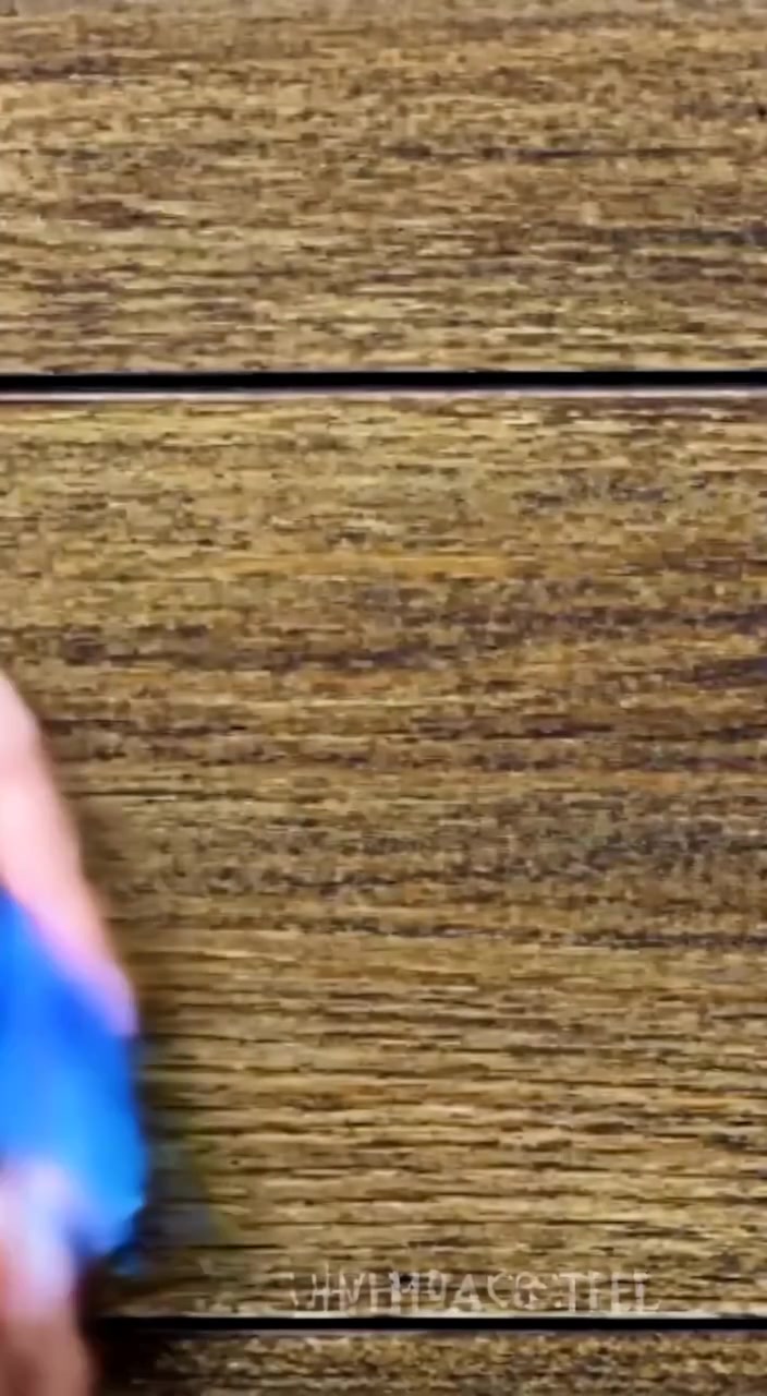 Colored chalk pieces gently rolling off the edge of the chalkboard, landing softly on the wooden floor.