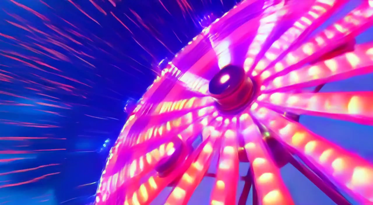 The colorful lights blur as the carnival ride wheel spins faster and faster in the vibrant evening atmosphere.