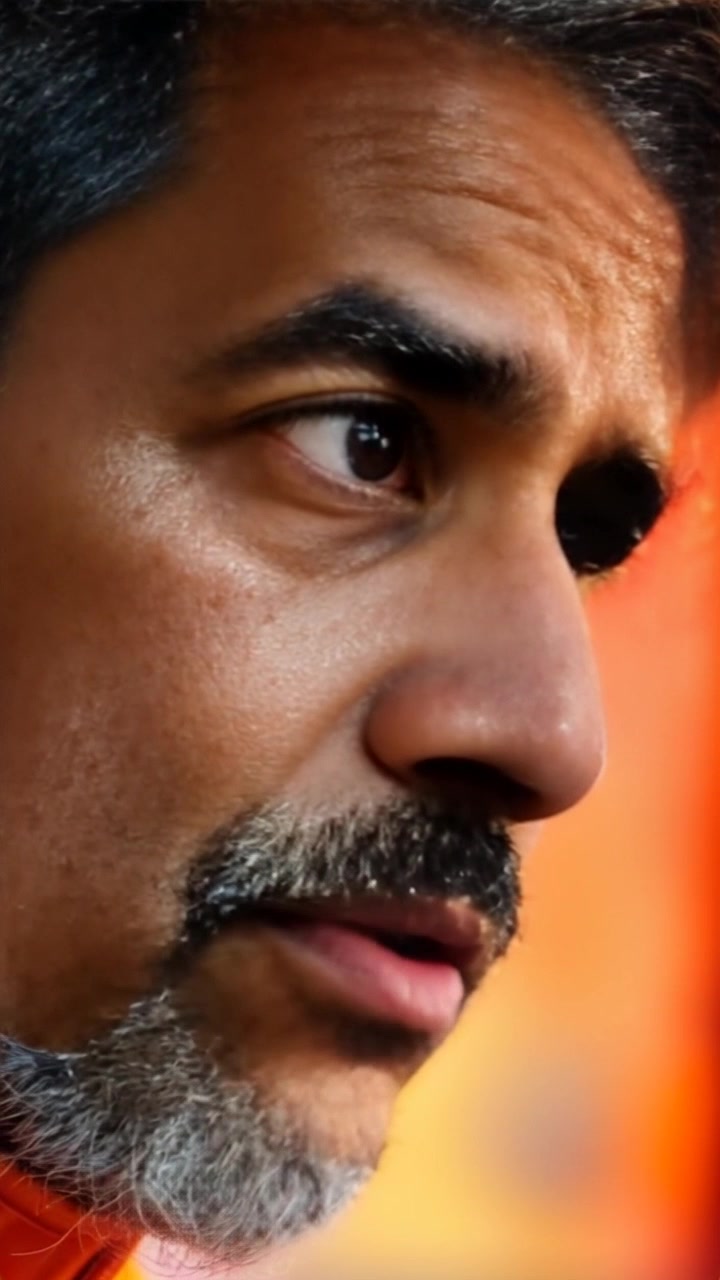 Subject: A man named Ramu with a weary expression, deep in thought as he talks to himself. Scene: Close-up of Ramu's face set against a softly blurred background, suggesting a quiet, introspective moment. Style: Soft, ambient lighting highlighting the contours of his face, casting gentle shadows that add depth. Motion: Camera slowly pushes in for an intimate close-up, capturing Ramu’s subtle expressions and the flicker of emotions crossing his features.