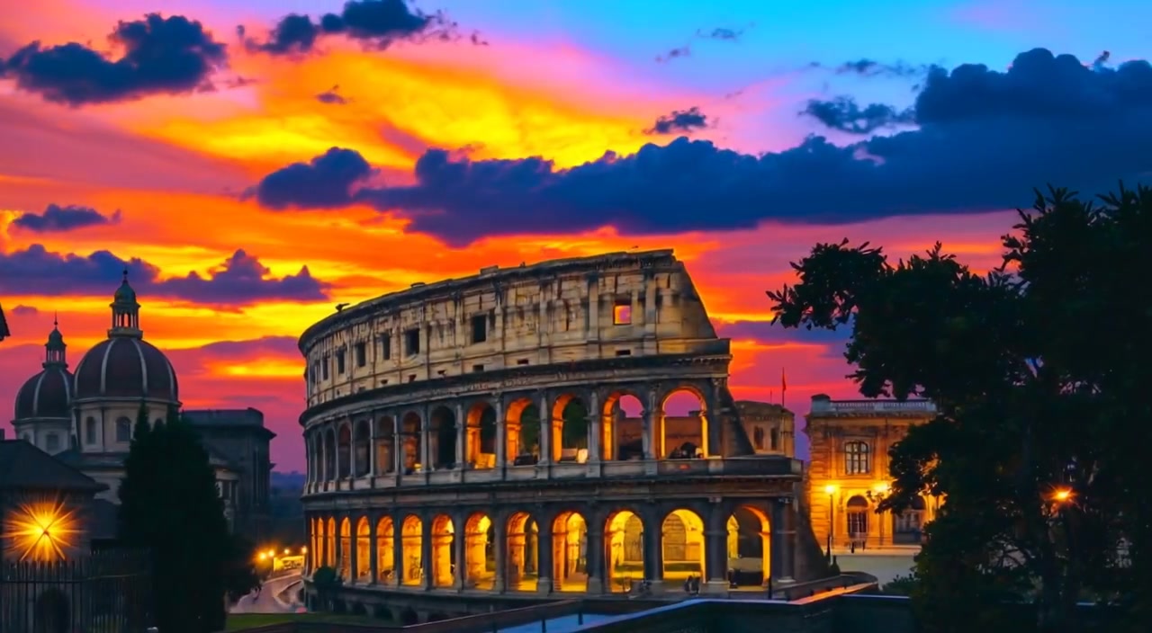 Clouds drift gently across the vibrant sunset sky above the majestic Roman Colosseum.