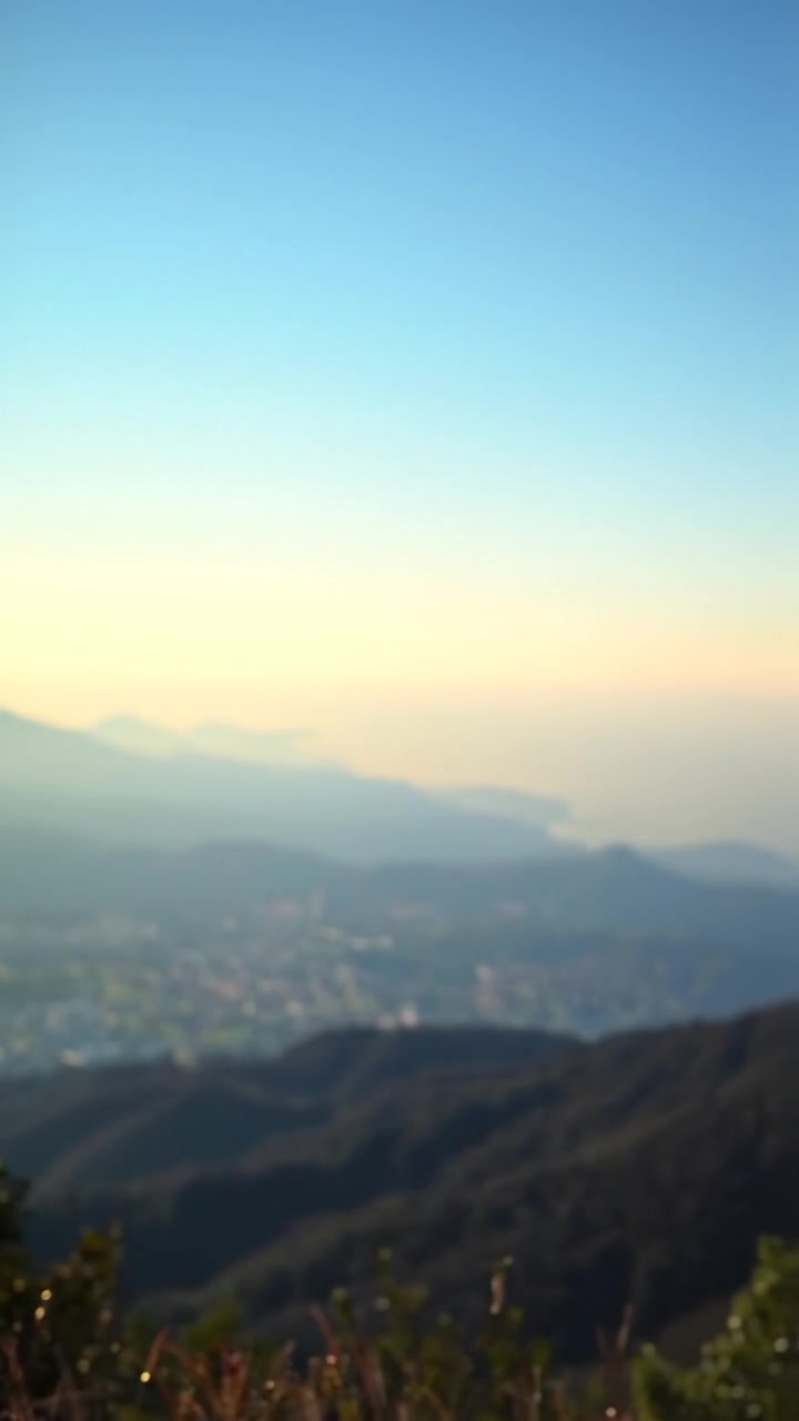 A scenic view of the horizon at sunrise, expansive and vibrant, with warm light illuminating distant mountains and rolling fields, captured in a smooth camera sweep with soft shadows, creating a sense of anticipation and adventure. The audio features gentle ambient sounds of nature.