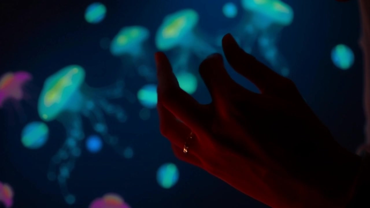 Scene: A close-up of hands fidgeting nervously, capturing the tension in the moment. Style: Soft, ambient lighting accentuating the details of the hands and the surrounding environment. Motion: The camera subtly zooms in on the hands, while they twitch and move restlessly, emphasizing the feeling of anxiety in the atmosphere.