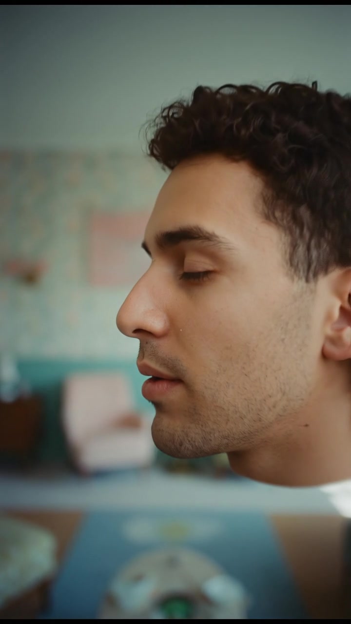 A close-up of the Mateo's face as he exhales slowly with a peaceful expression.