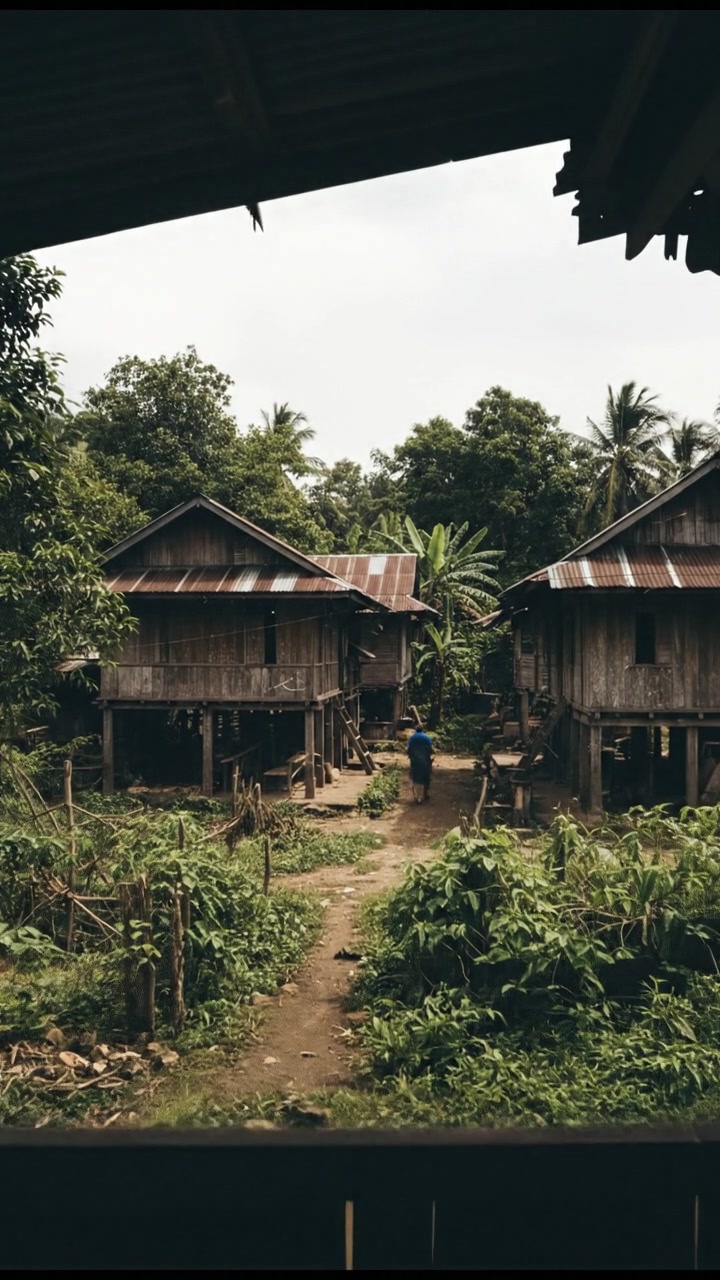 An Indonesian village landscape, showcasing traditional wooden houses and lush greenery.