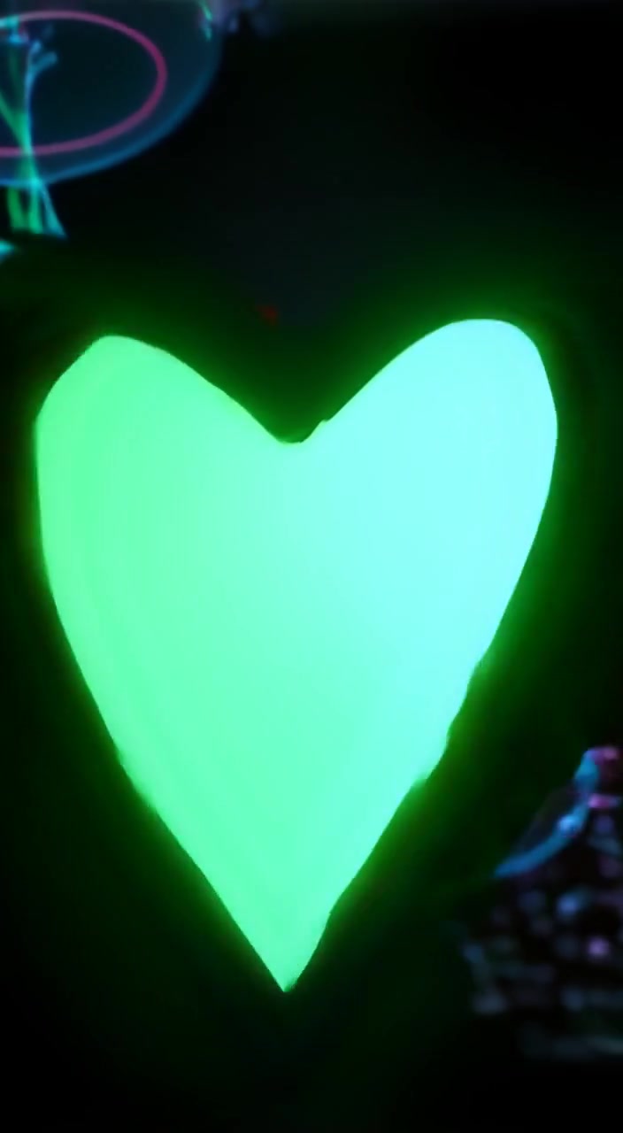 The heart beats gently, pulsating with a soft, glowing light that flickers around its rhythmic motion.